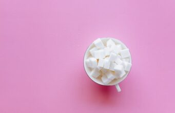 How Sugar Sabotages Your Memory human brain surrounded by refined sugar cubes neuroinflammation cognitive health memory impairment