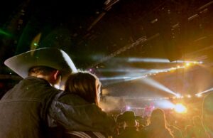 Light-Up Cowboy Hats: Are They Worth It? Light-up cowboy hats at a vibrant music festival with glowing LED brims