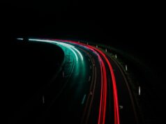 No Boring Cars Allowed and Other Tales of the Automobile Automobile on a neon-lit highway at night