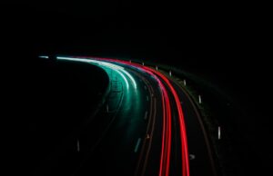 No Boring Cars Allowed and Other Tales of the Automobile Automobile on a neon-lit highway at night