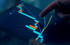 Smart Investing: How to Grow Your Business Wealth Safely Smart investing business owner reviewing financial portfolio on digital tablet