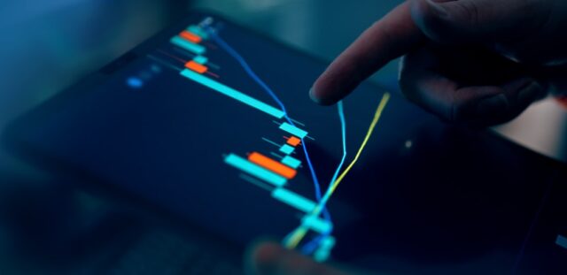 Smart investing business owner reviewing financial portfolio on digital tablet