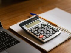 Travel Insurance Cost Calculator & Pricing Guide travel insurance cost calculator with laptop and calculator on desk