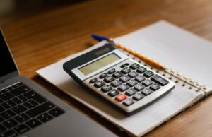 Travel Insurance Cost Calculator & Pricing Guide travel insurance cost calculator with laptop and calculator on desk