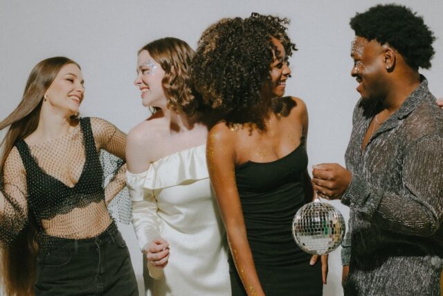What to wear to a disco-themed party, Studio 54 shimmering dance floor, retro glamour 2026