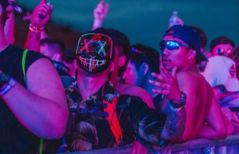 Your Next Festival Bucket List festival crowd under neon lights at a global music event