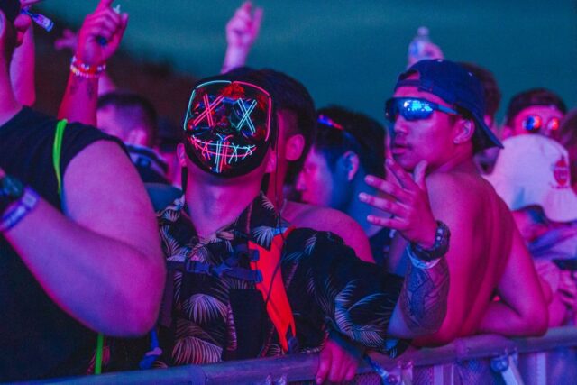 your-next-festival-bucket-list-image festival crowd under neon lights at a global music event